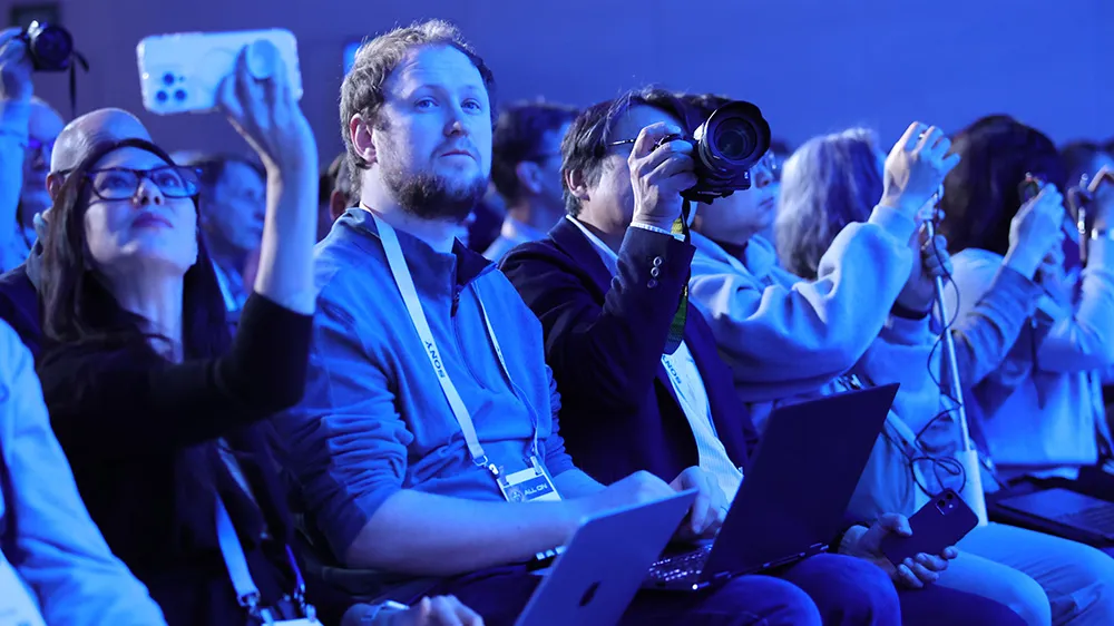 ALT Text: A group of people taking picture of the CES keynotes
